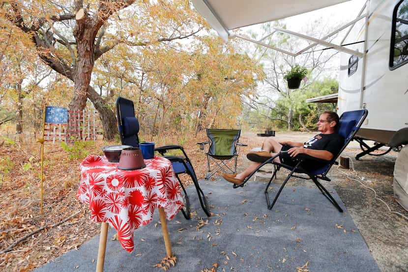 
Clarence Battaglia of Carrollton relaxes next to his trailer at Cedar Hill State Park....