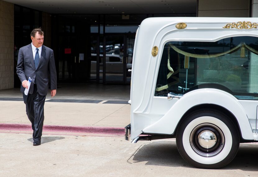 Mayor Mike Rawlings passes a hearse carrying the casket of Muhlaysia Booker as he exits her...