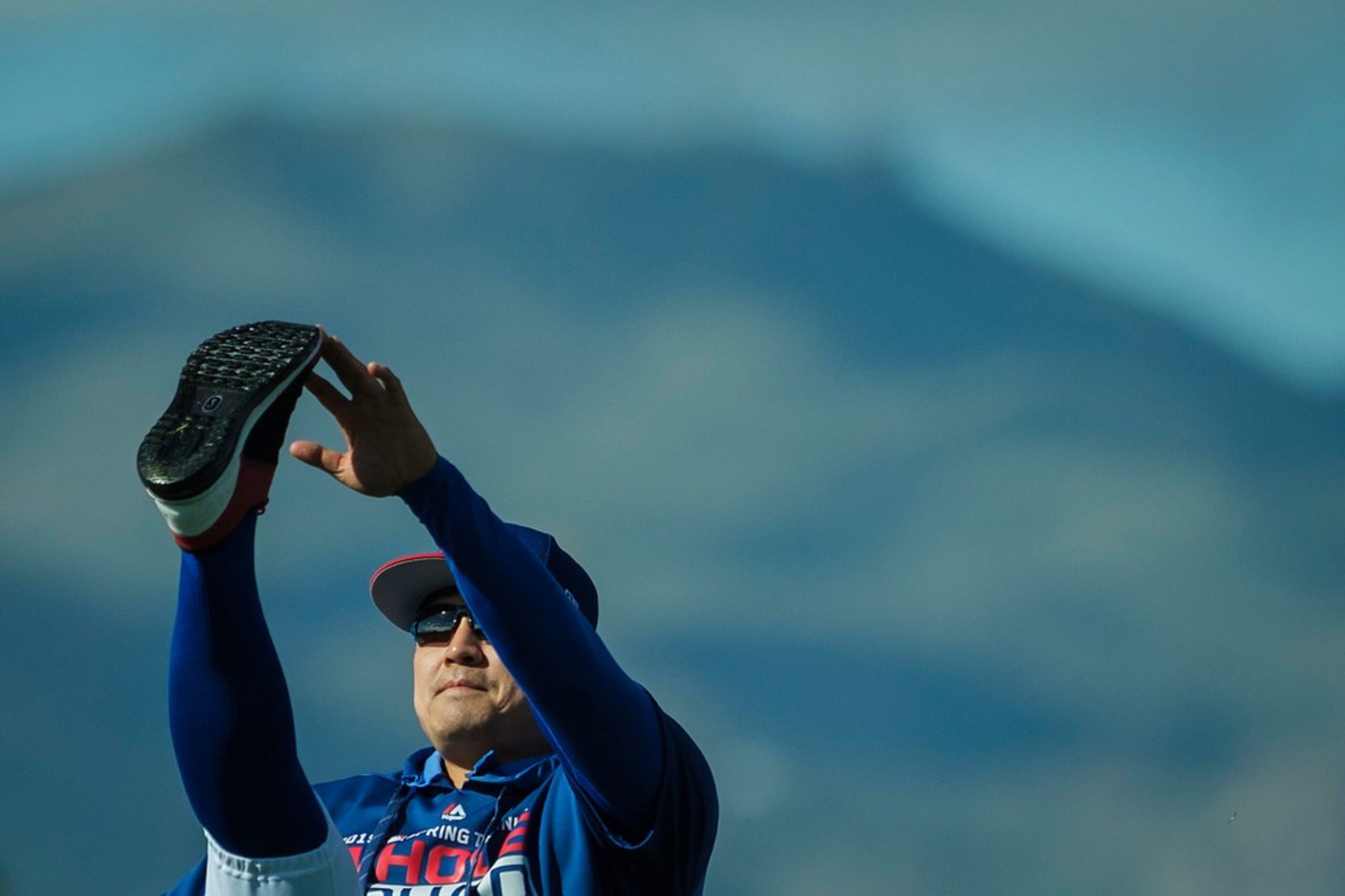 Texas Rangers outfielder Shin-Soo Choo stretches during the first full squad spring training...