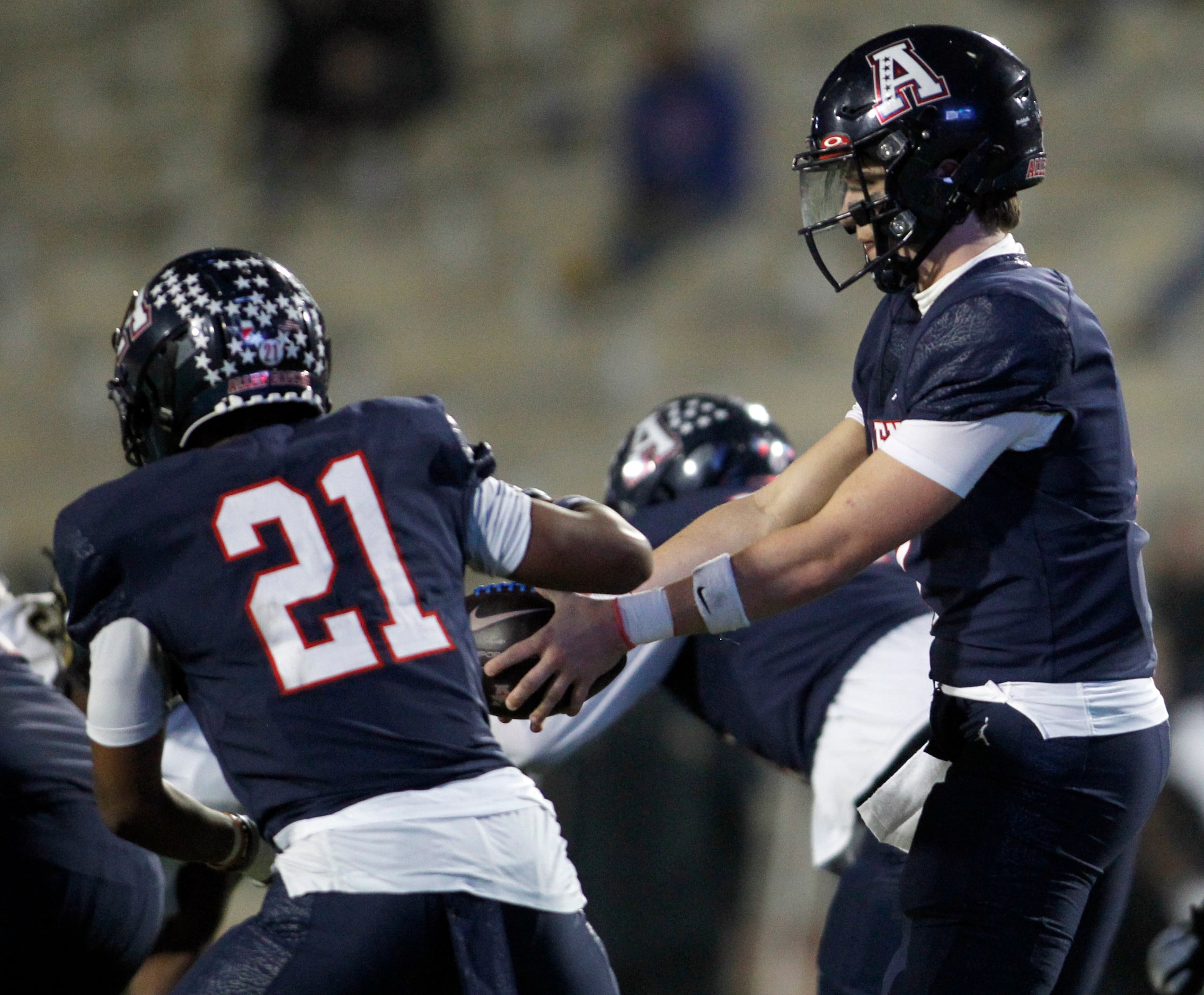 Allen Eagles quarterback Brady Bricker (7), right, hands off to running back Jaden Hambric...