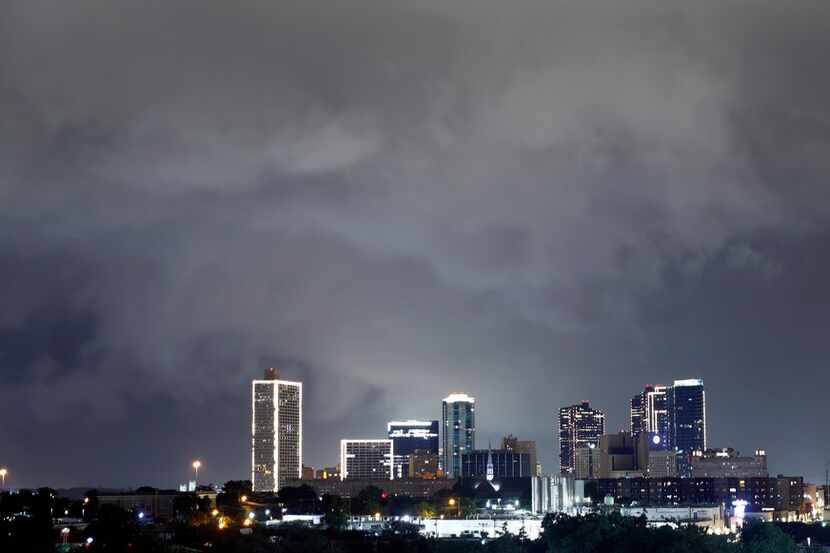 A slow-moving thunderstorm packing 50+ mph winds rolls over downtown Fort Worth, Wednesday...