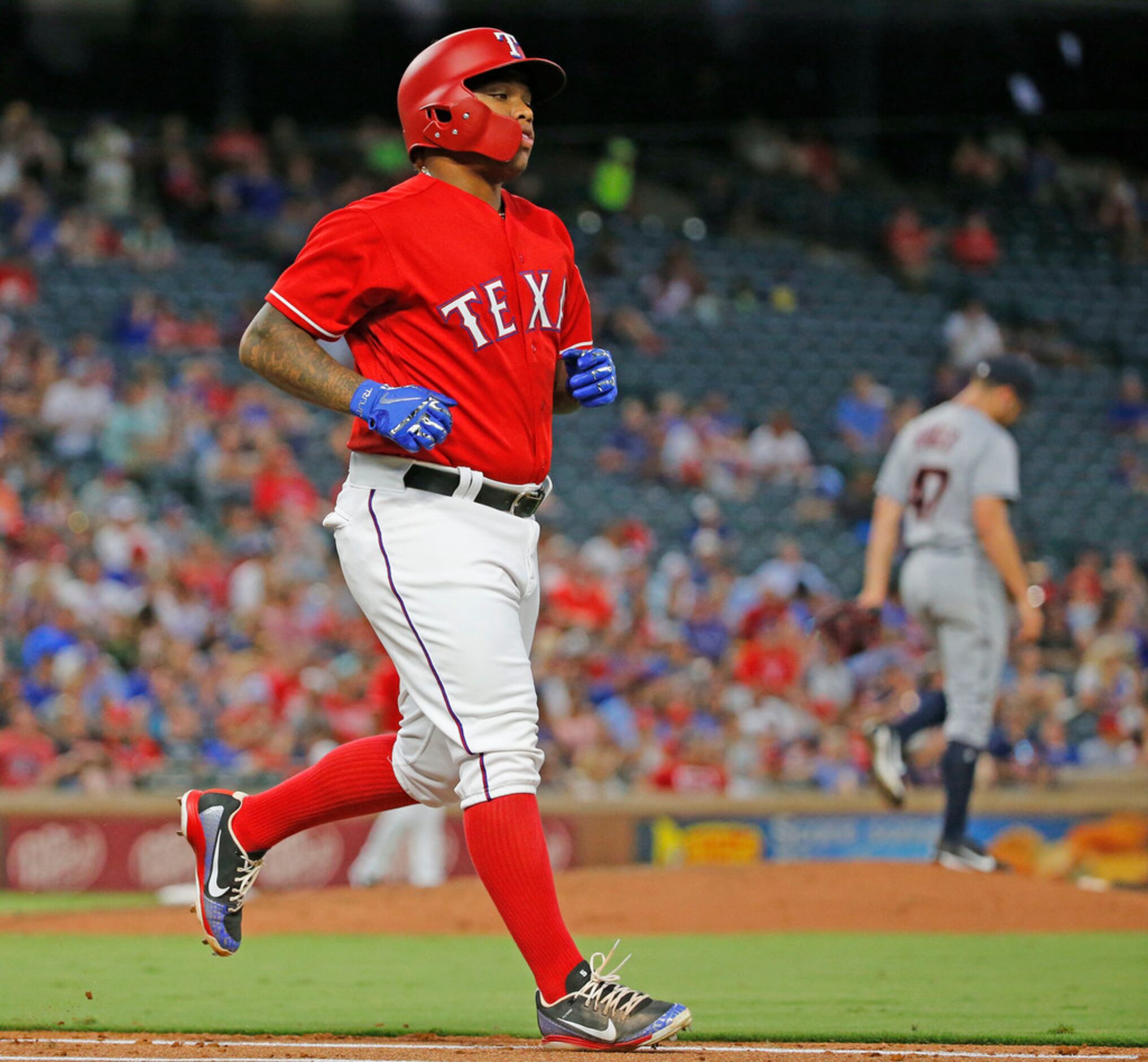 Texas Rangers designated hitter Willie Calhoun (5) heads to first after walking in the...