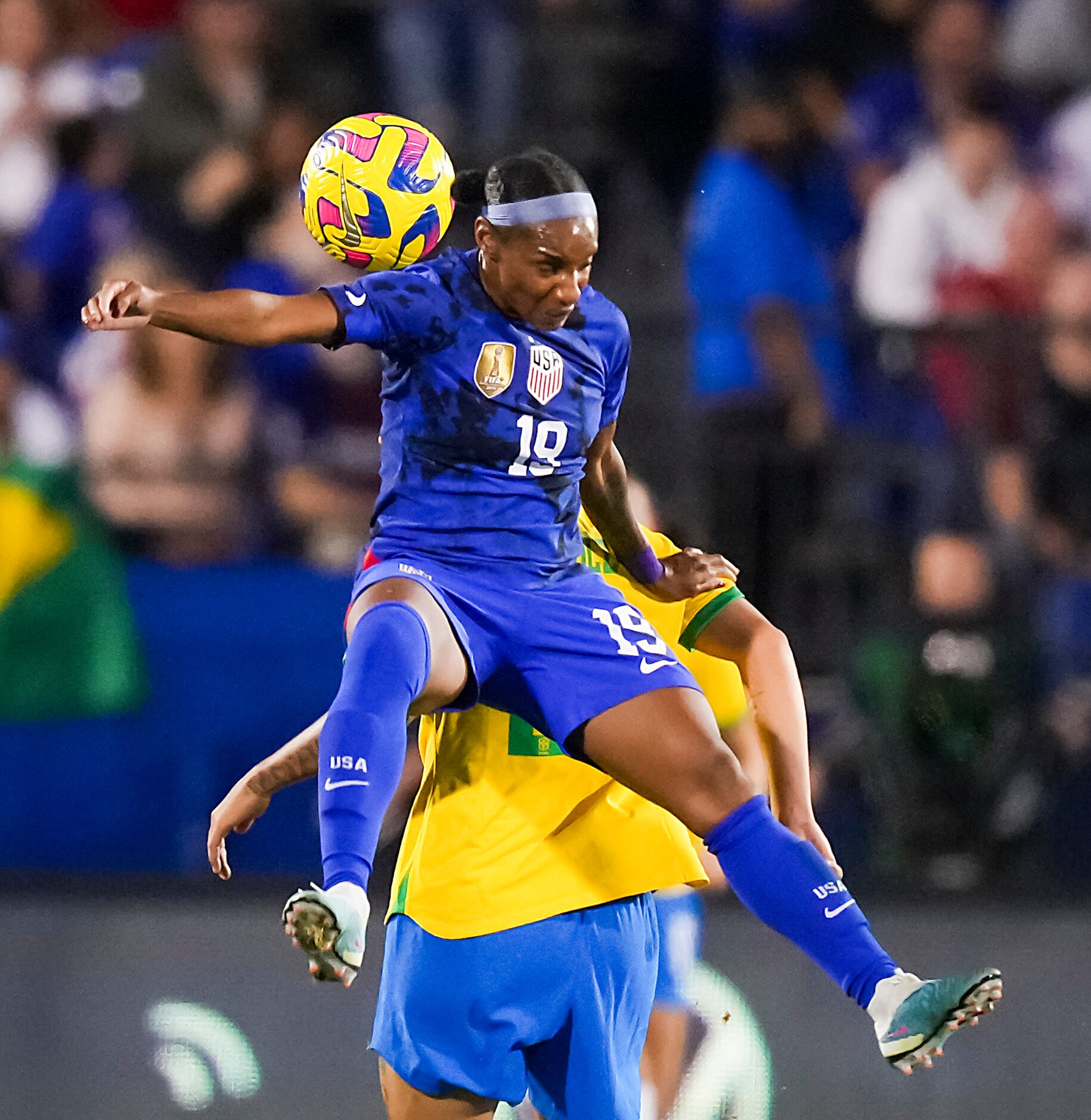 United States defender Crystal Dunn (19) goes up for a header against Brazil forward Marta...