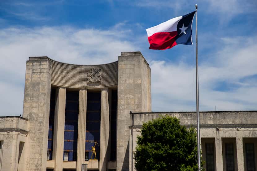 A Texas flag flies over the Hall of State at Fair Park.