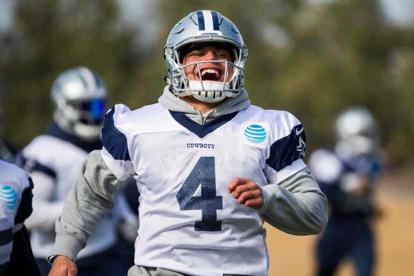 Dallas Cowboys quarterback Dak Prescott (4) smiles as he runs during their practice on...