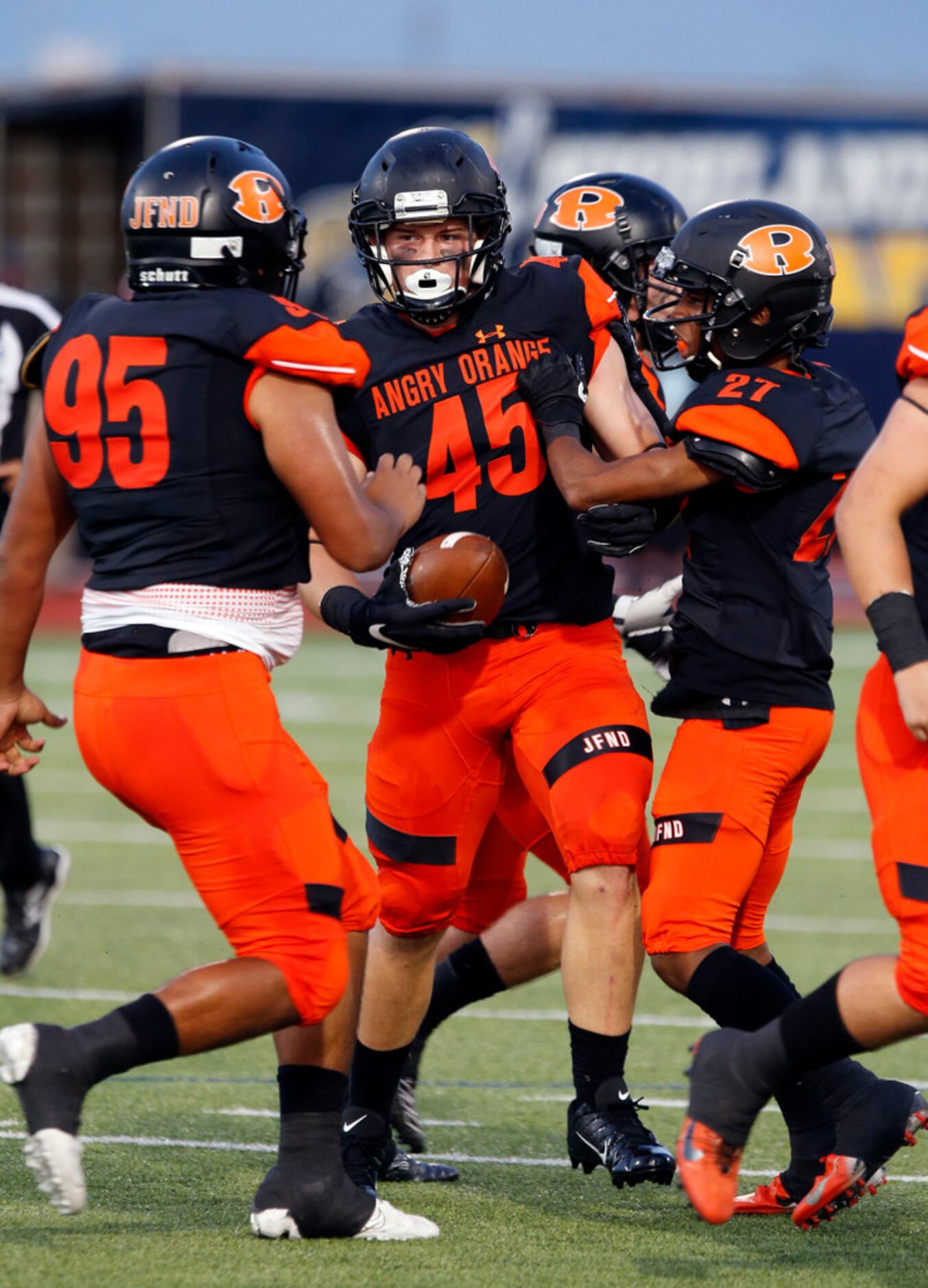 Rockwall linebacker Jake Edwards (45) is congratulated by teammates after grabbing a...