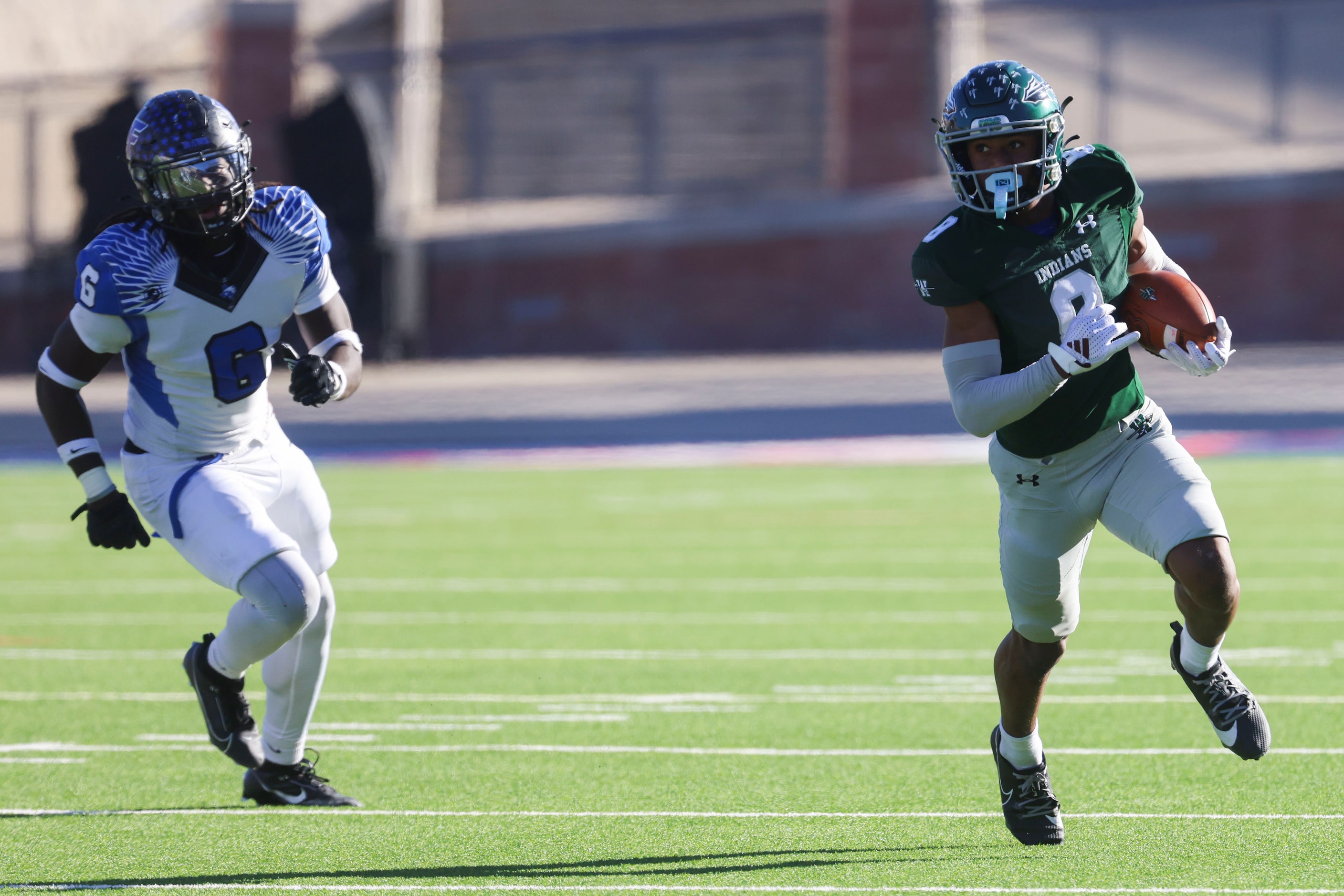 Waxahachie High’s Kohen Brown (right) runs for a yardage past North Forney High’s J’ynv...