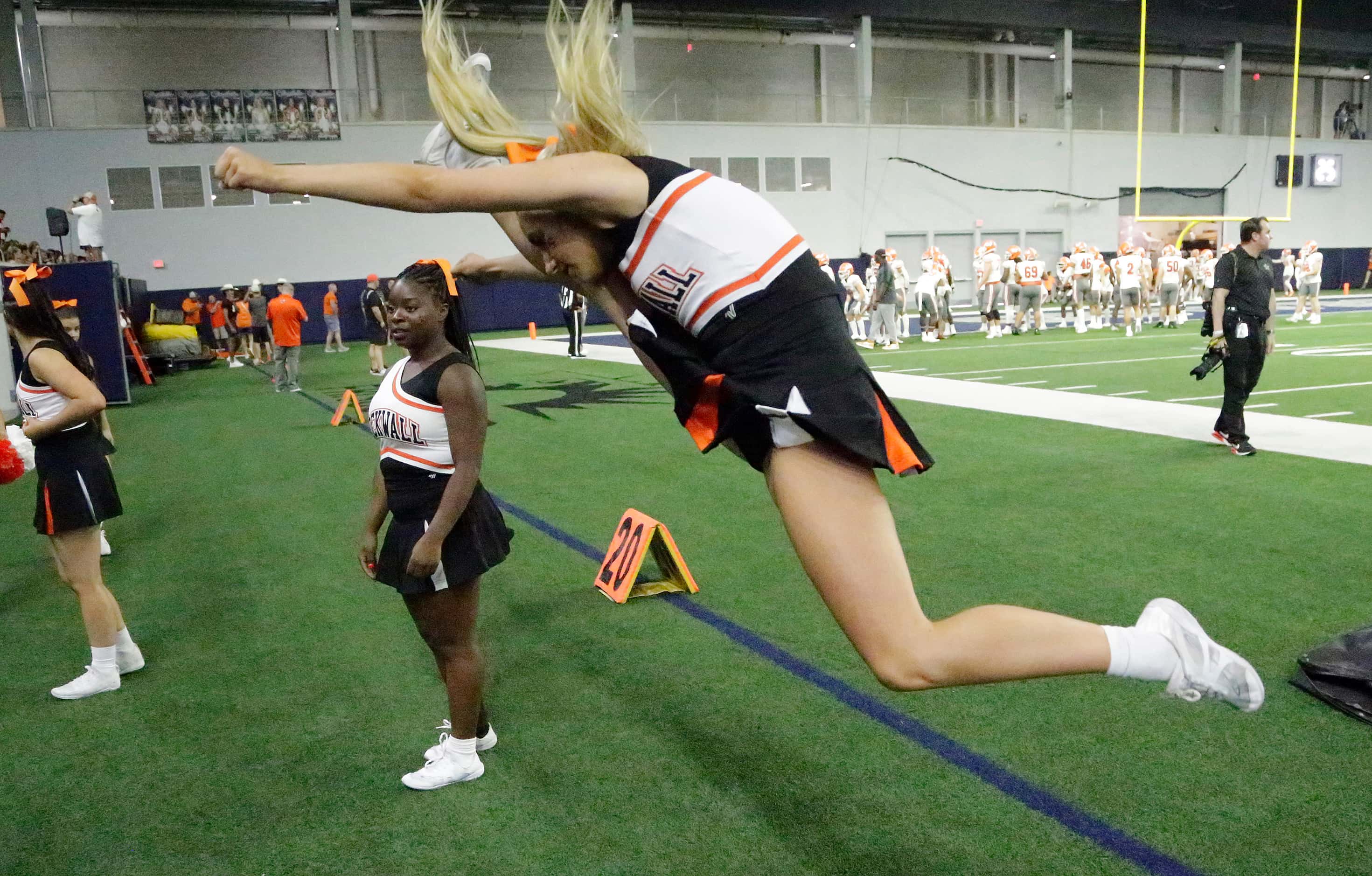 Rockwall High School cheerleader Presley Beck, 17, practices her moves before kickoff as...