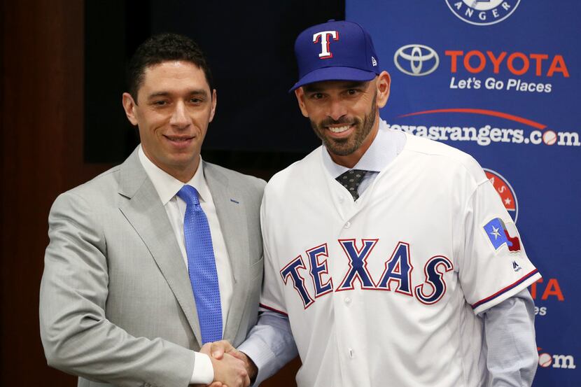 Texas Rangers' new manager Chris Woodward shakes hands with General Manager Jon Daniels...