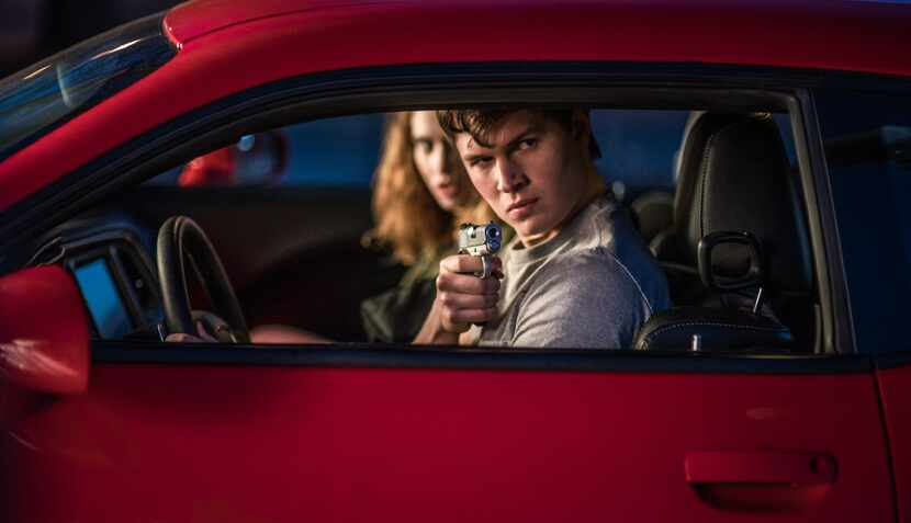 Baby (Ansel Elgort) and Debora (Lily James) jack a car to get away in the action movie,...