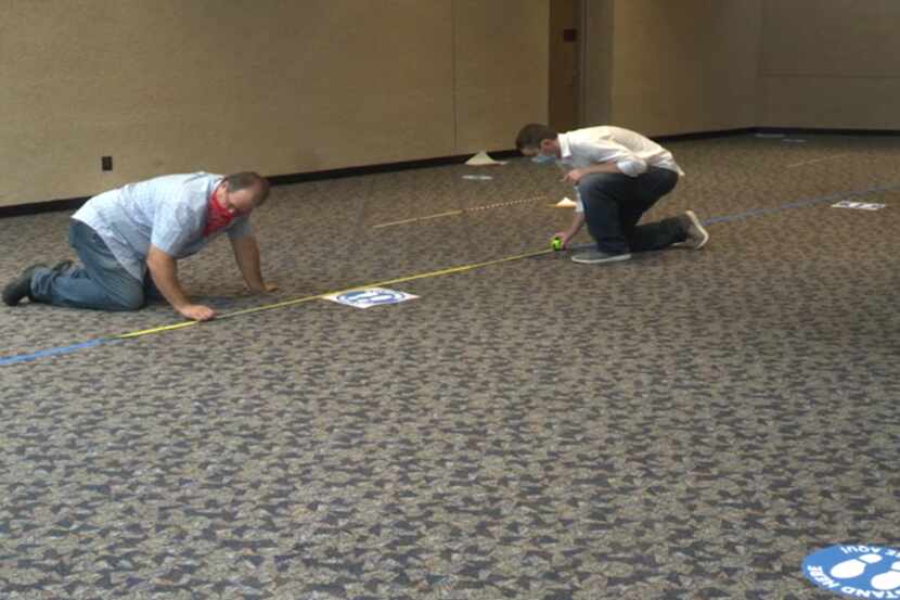 Workers are shown preparing the Richardson Civic Center for early voting in this still of a...