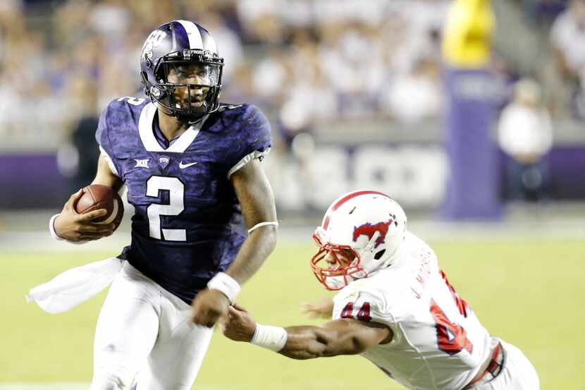 TCU Horned Frogs quarterback Trevone Boykin (2) runs past Southern Methodist Mustangs...