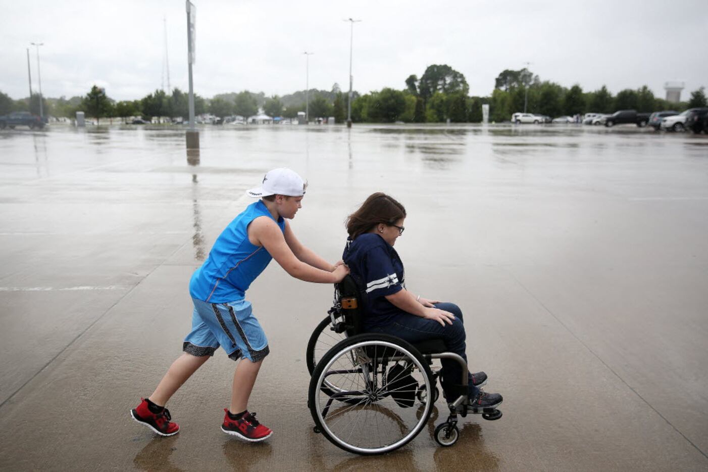 Holton Wilson, 11, and his sister, Alexis Wilson, of San Angelo made their way toward AT&T...