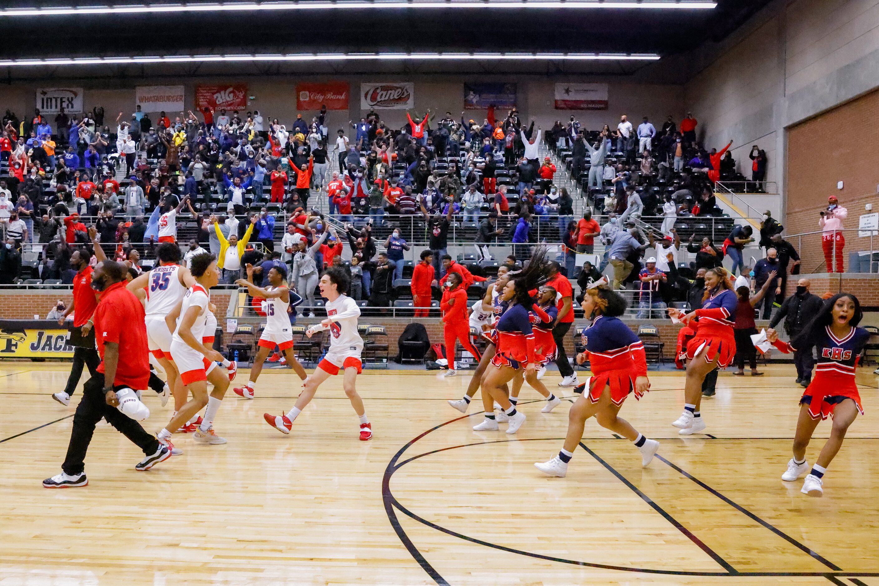 Kimball celebrates their win over Lancaster following overtime of a boys basketball UIL...