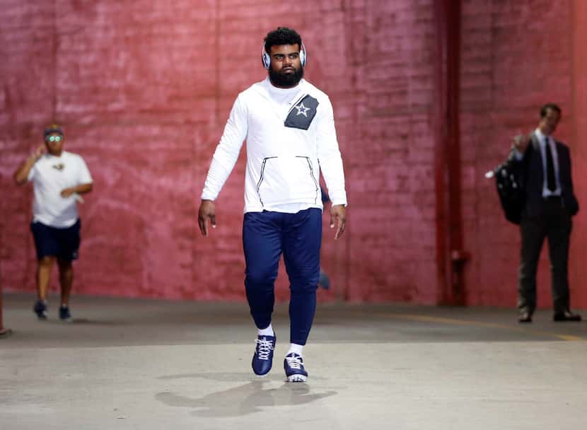 Dallas Cowboys running back Ezekiel Elliott makes his way to the field to warmup before a...