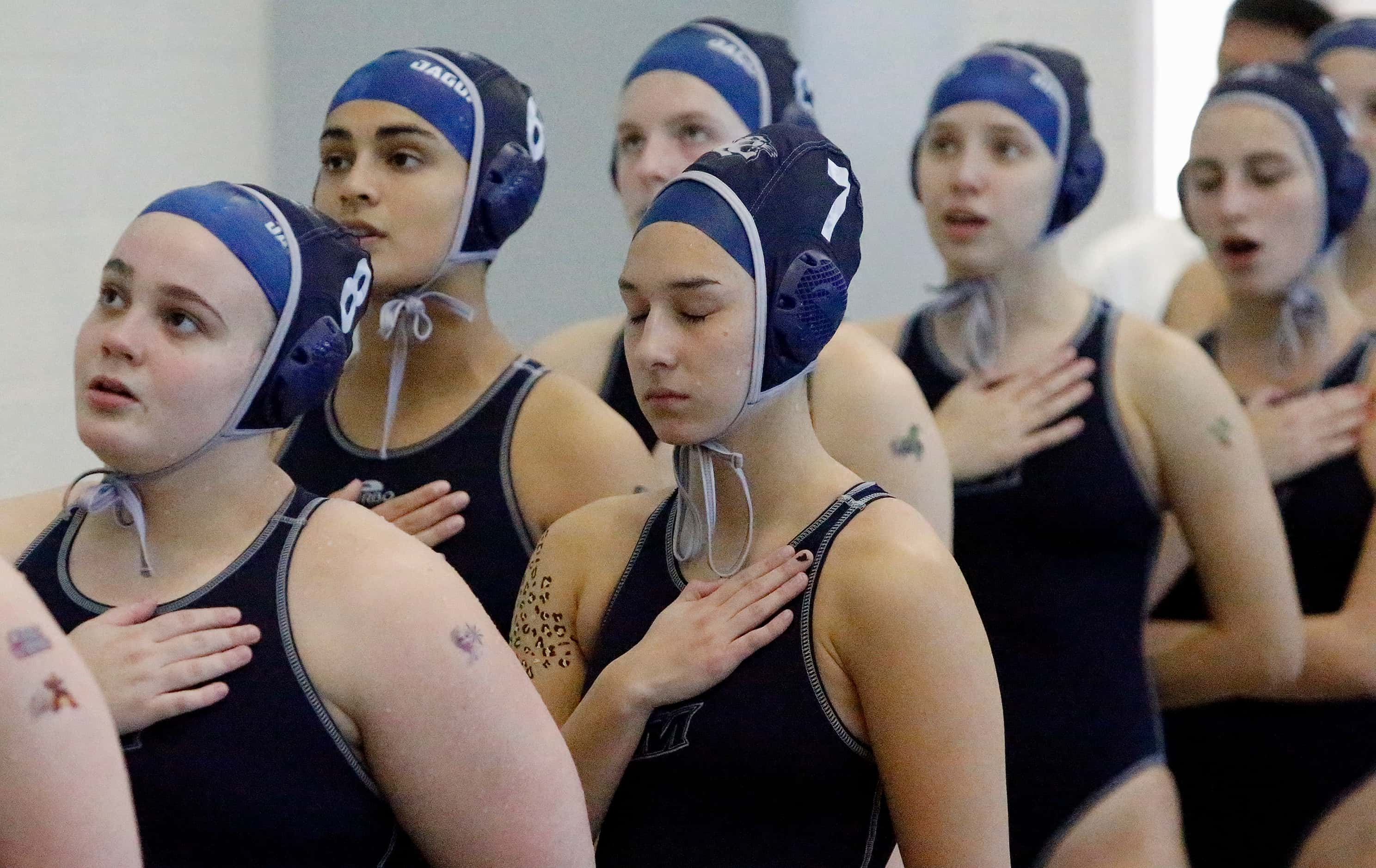 Flower Mound’s Gwyneth Le (7) gets game ready during the national anthem as Southlake High...