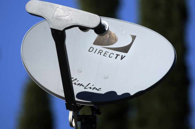 A  DirecTV satellite receiver dish is displayed on a home in Simi Valley, Calif....