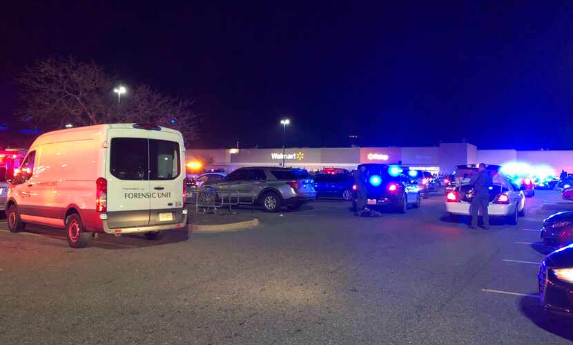 In this image taken from video, police respond to the scene of a fatal shooting at a Walmart...