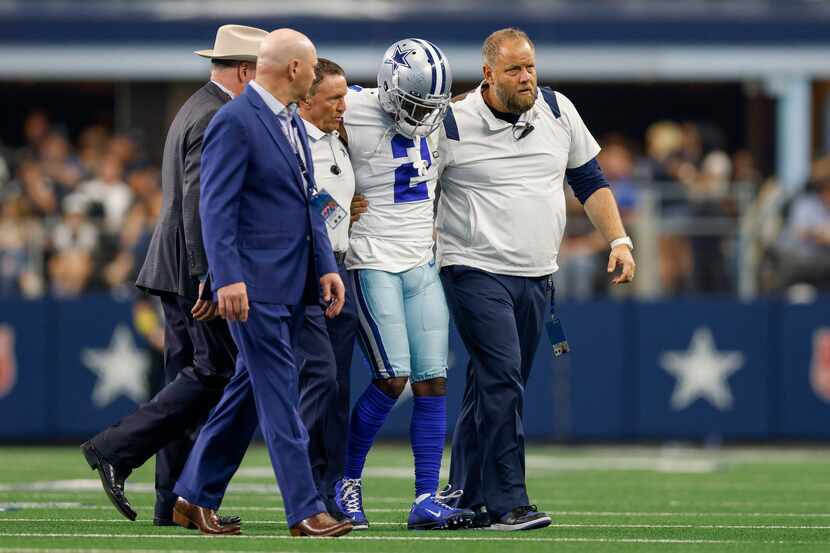 Dallas Cowboys cornerback Jourdan Lewis (2) is helped off the field after suffering a leg...
