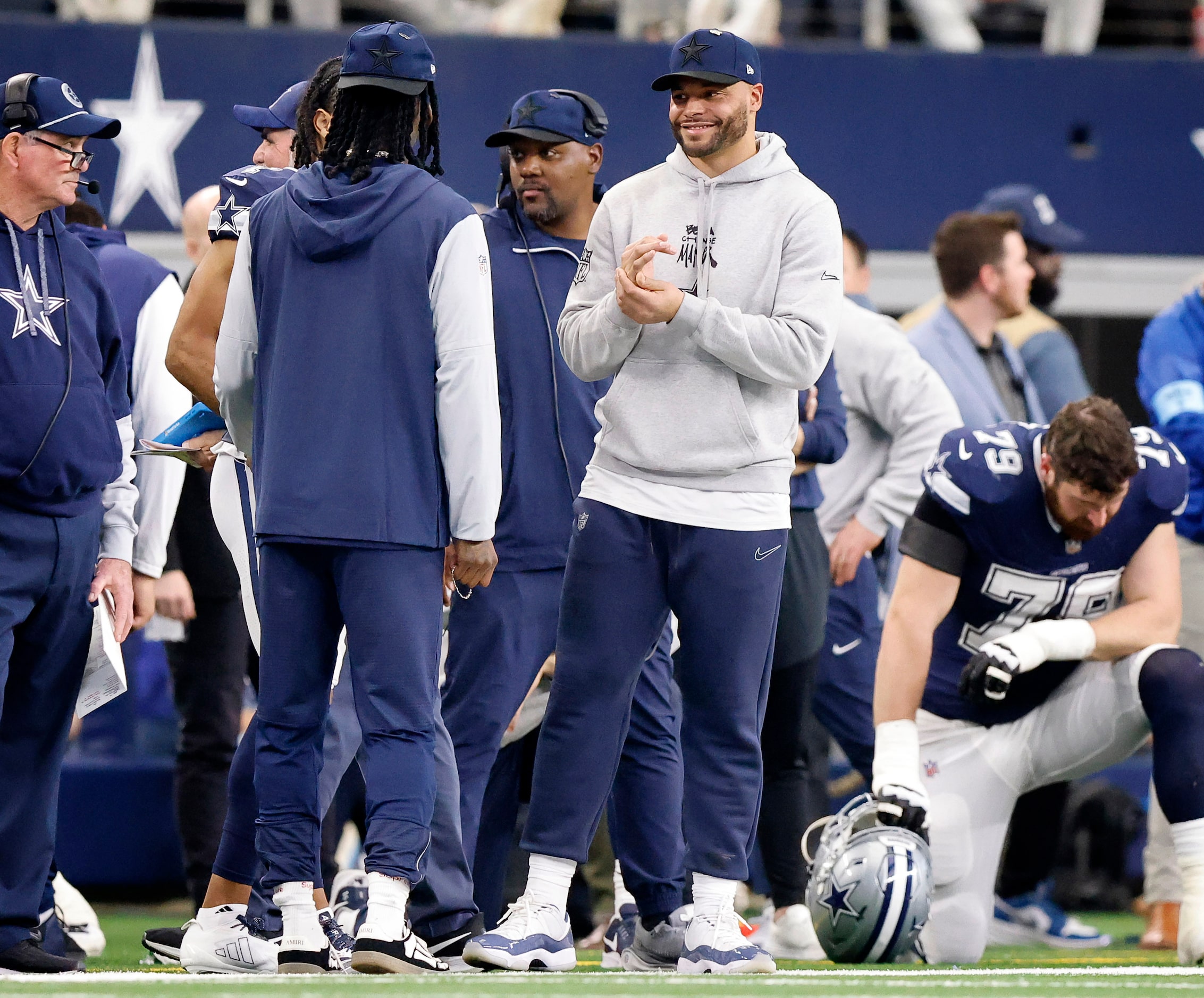 Injured Dallas Cowboys quarterback Dak Prescott (right) visits with injured wide receiver...