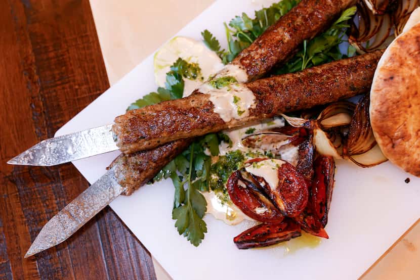 A large-format platter with two 10-ounce lamb kebabs is one way a table of guests can share...