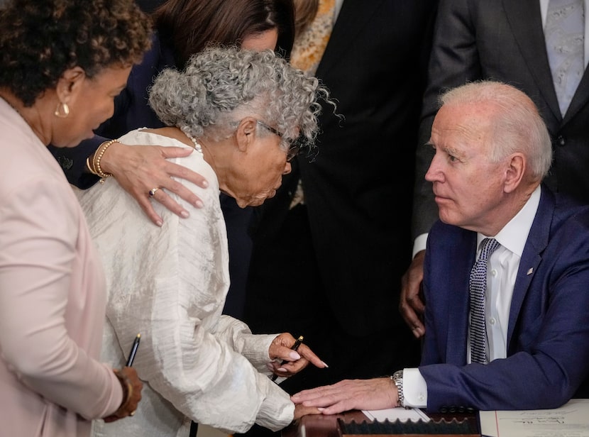 Opal Lee speaks with President Joe Biden after he signed the Juneteenth National...