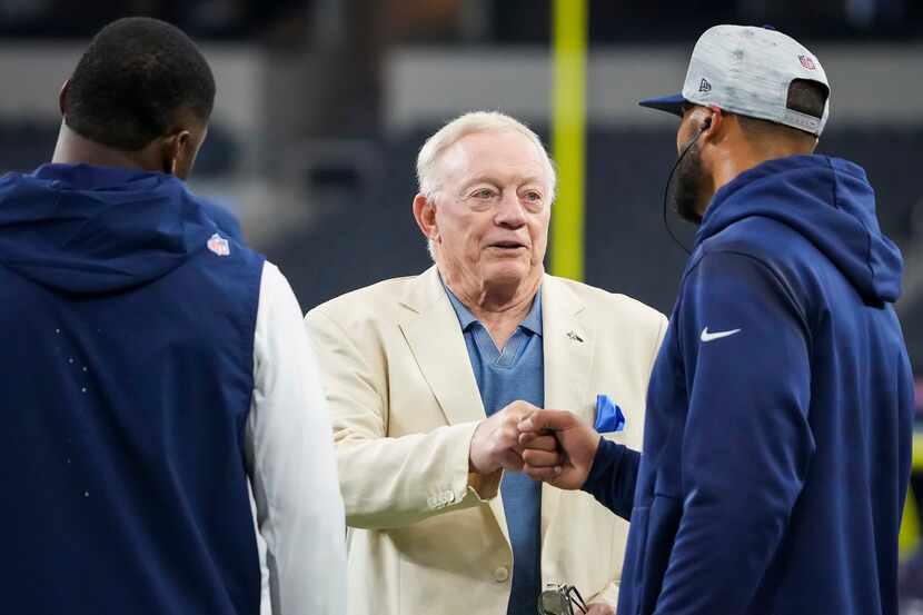 Dallas Cowboys owner and general manager Jerry Jones fist bumps quarterback Dak Prescott as...