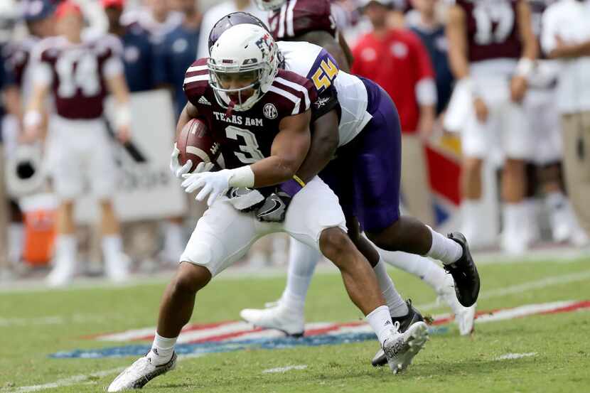 Texas A&M wide receiver Christian Kirk (3) is wrapped up by Prairie View A&M linebacker...
