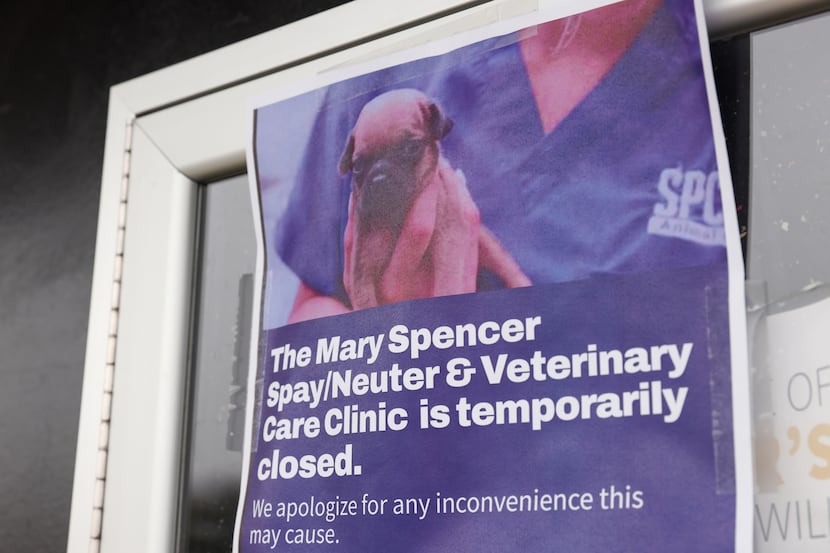 Signs taped to the doors of the SPCA of Texas' Mary Spencer Spay/Neuter & Wellness Clinic on...