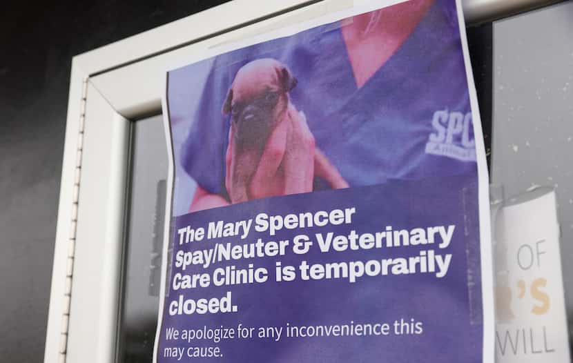 Signs taped to the doors of the SPCA of Texas' Mary Spencer Spay/Neuter & Wellness Clinic...