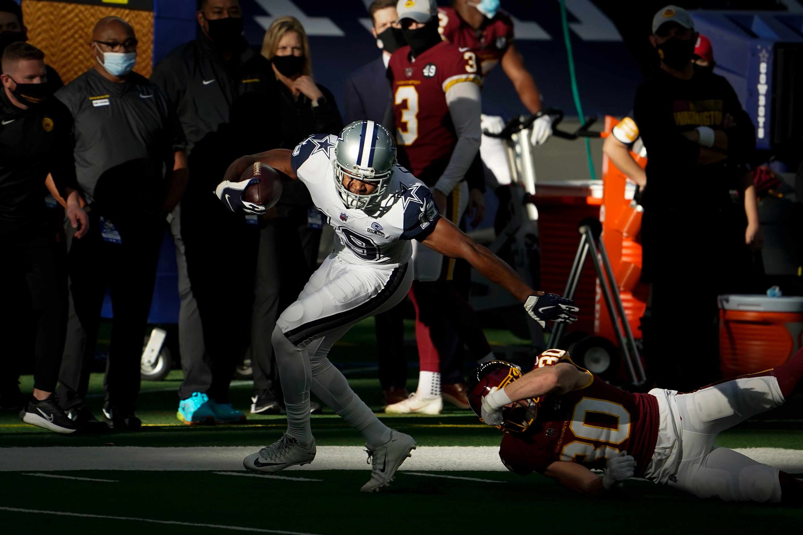 Dallas Cowboys wide receiver Amari Cooper (19) slips past Washington Football Team free...