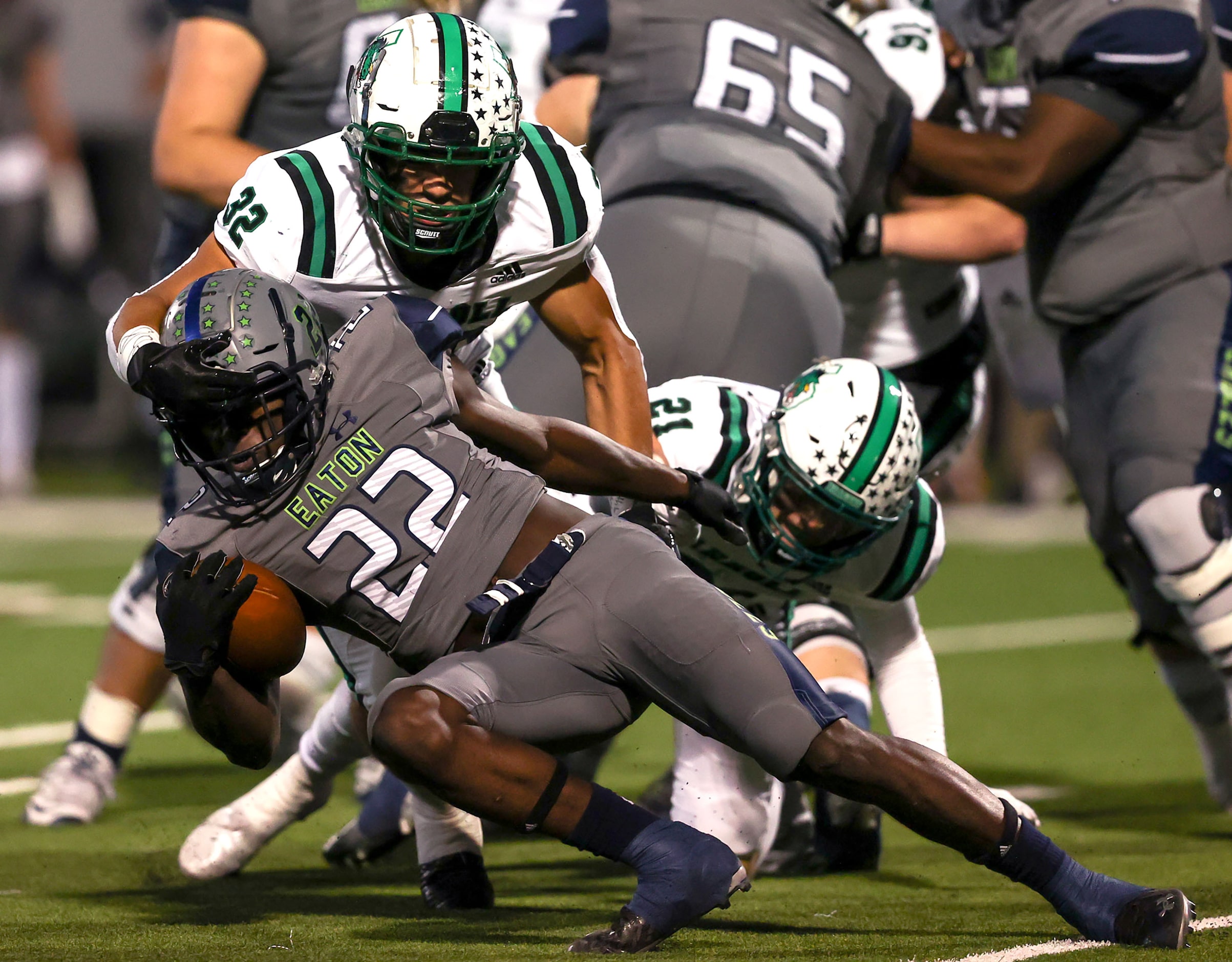 Eaton running back JB Brown (22) is stopped by Southlake Carroll linebacker Benecio Porras...