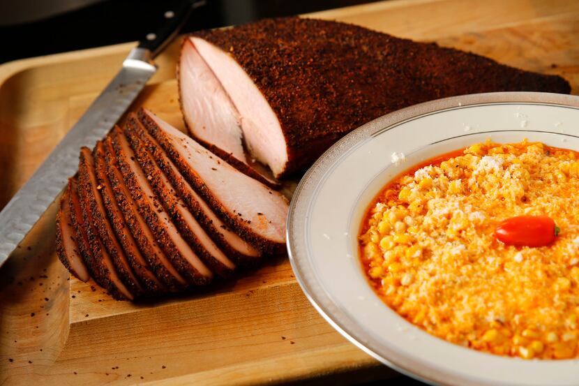 Cattleack Barbecue pitmaster Todd David displays his cheesy chipotle corn (right) and smoked...