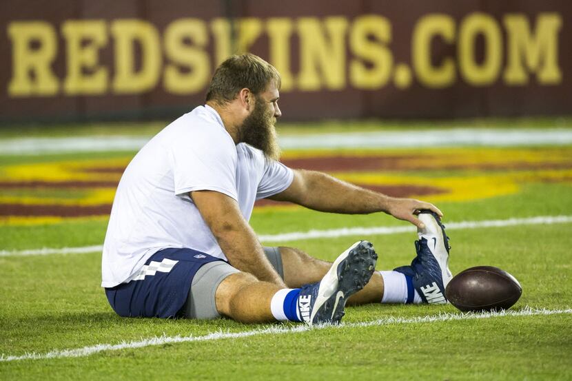 Dallas Cowboys center Travis Frederick stretches before an NFL football game against the...