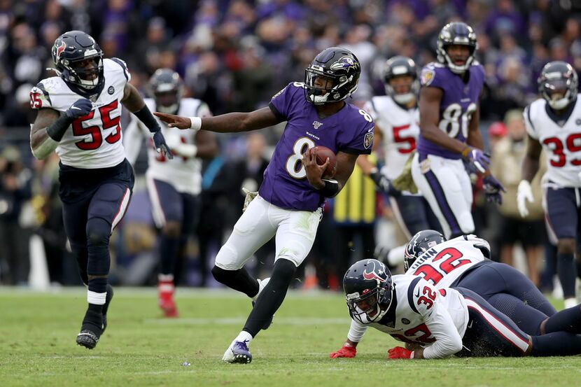 BALTIMORE, MARYLAND - NOVEMBER 17: Lamar Jackson #8 of the Baltimore Ravens rushes for a...