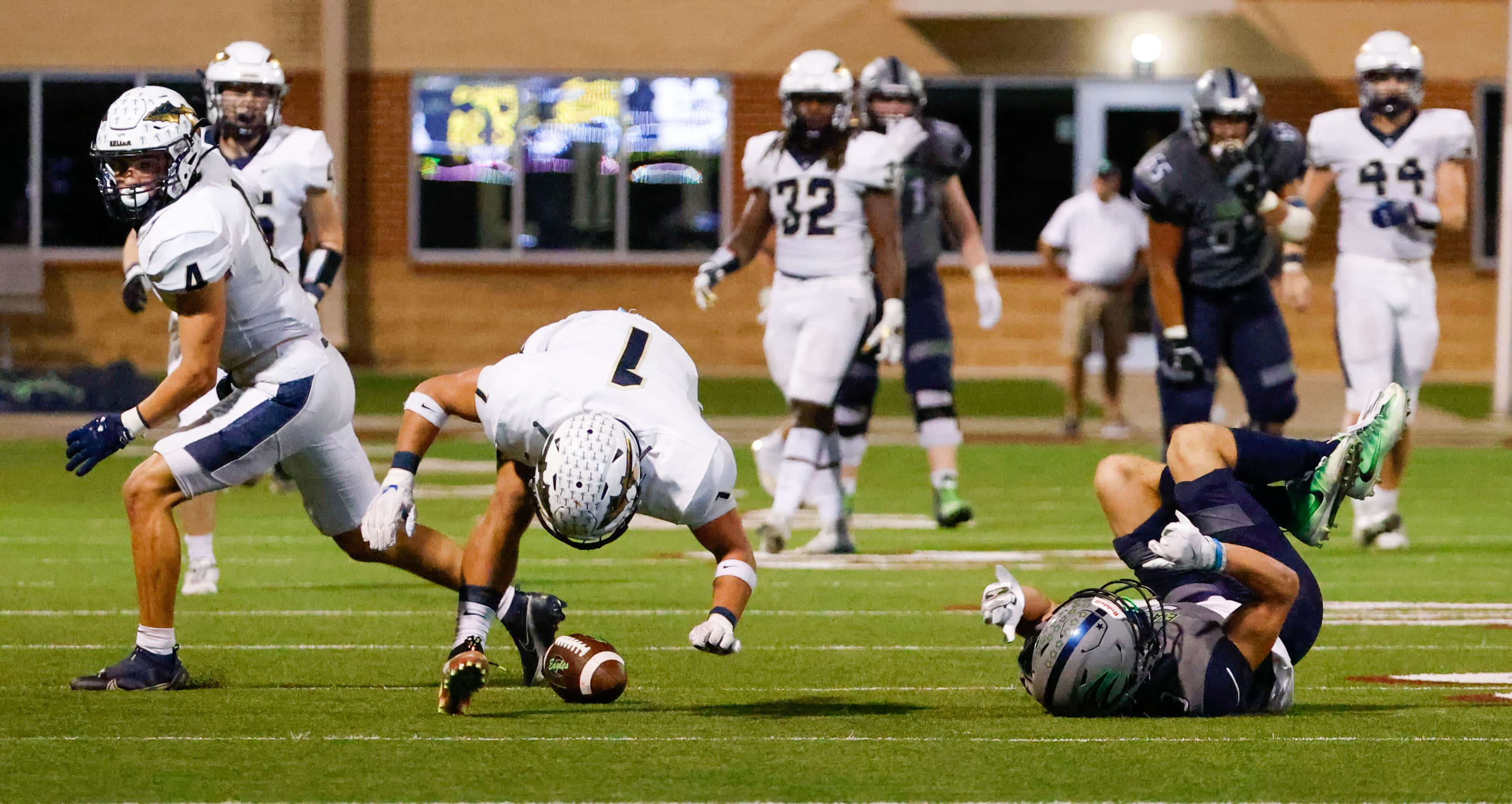 Keller High School defensive back Matthew Anderson (1) reaches for the ball after it slips...