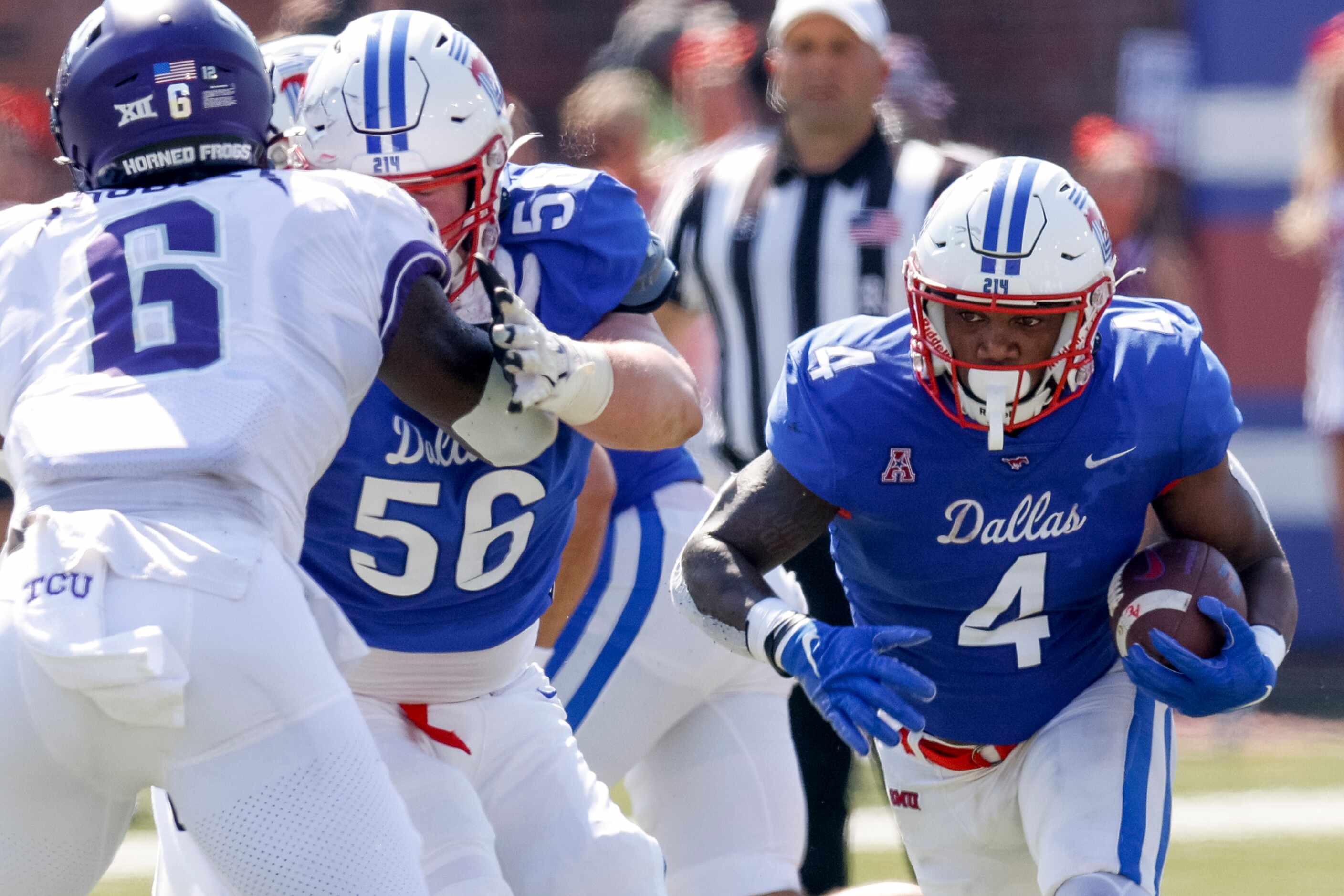 SMU running back Tre Siggers (4) runs the ball around a blocking offensive lineman Branson...