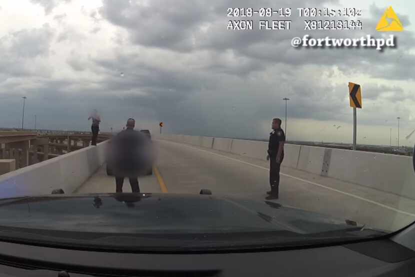 Two Fort Worth police officers approach a suicidal woman standing on a highway bridge.