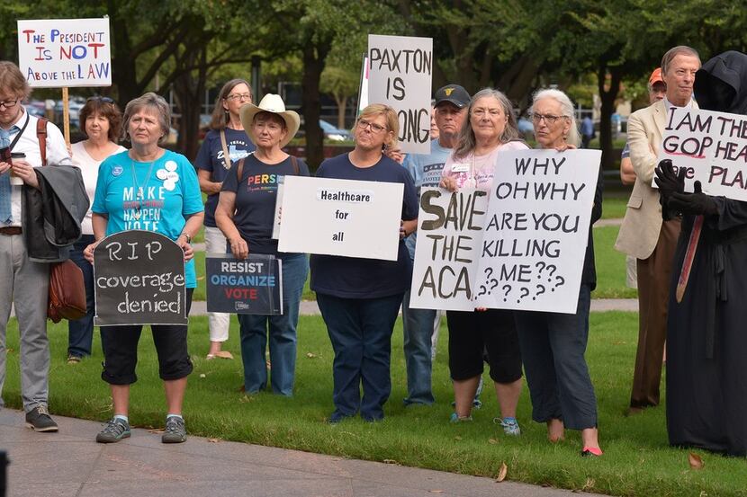 Supporters of the Affordable Care Act protest during a rally at Burnett Park in Fort Worth,...