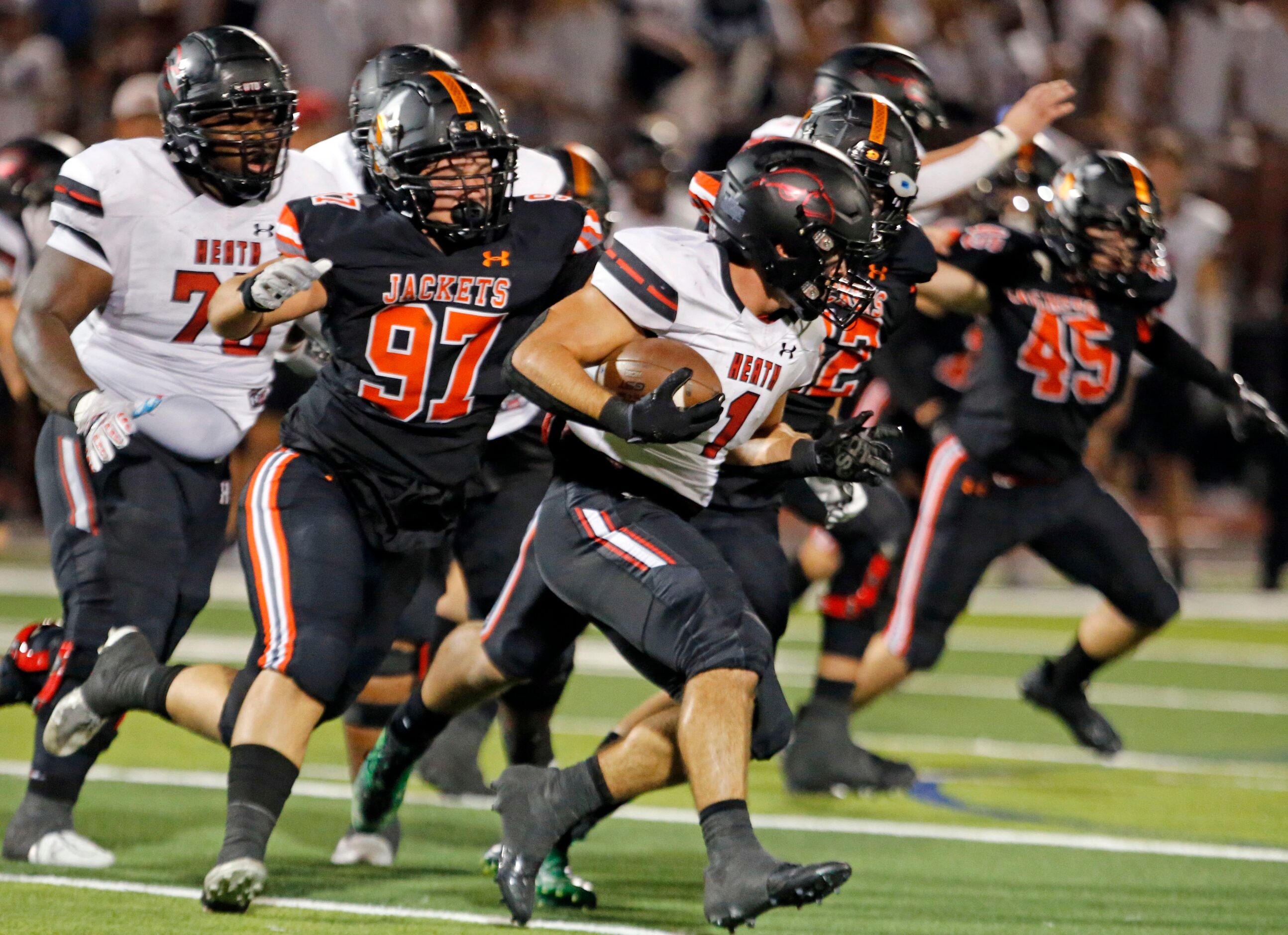 Rockwall high defender Hunter Aiello (97) chases Rockwall-Heath’s Malachi Tuesno (1) during...