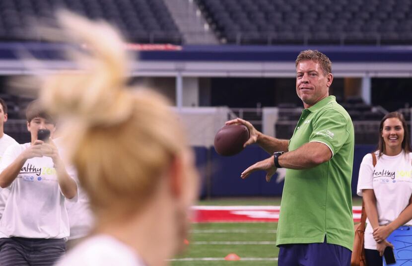
Troy Aikman threw the ball to Amy Holderman, principal of Bennett Elementary School in...