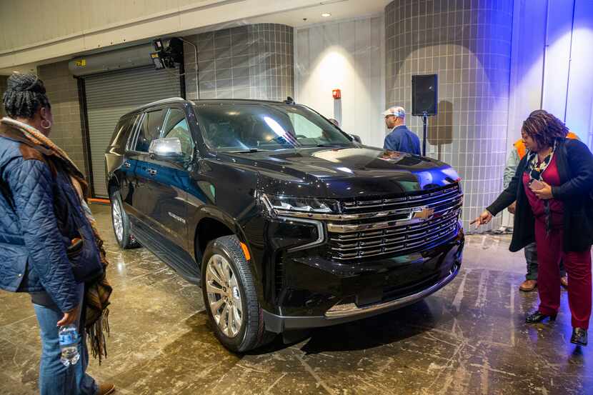 Attendees survey the new Chevrolet Suburban during the unveiling event of the...