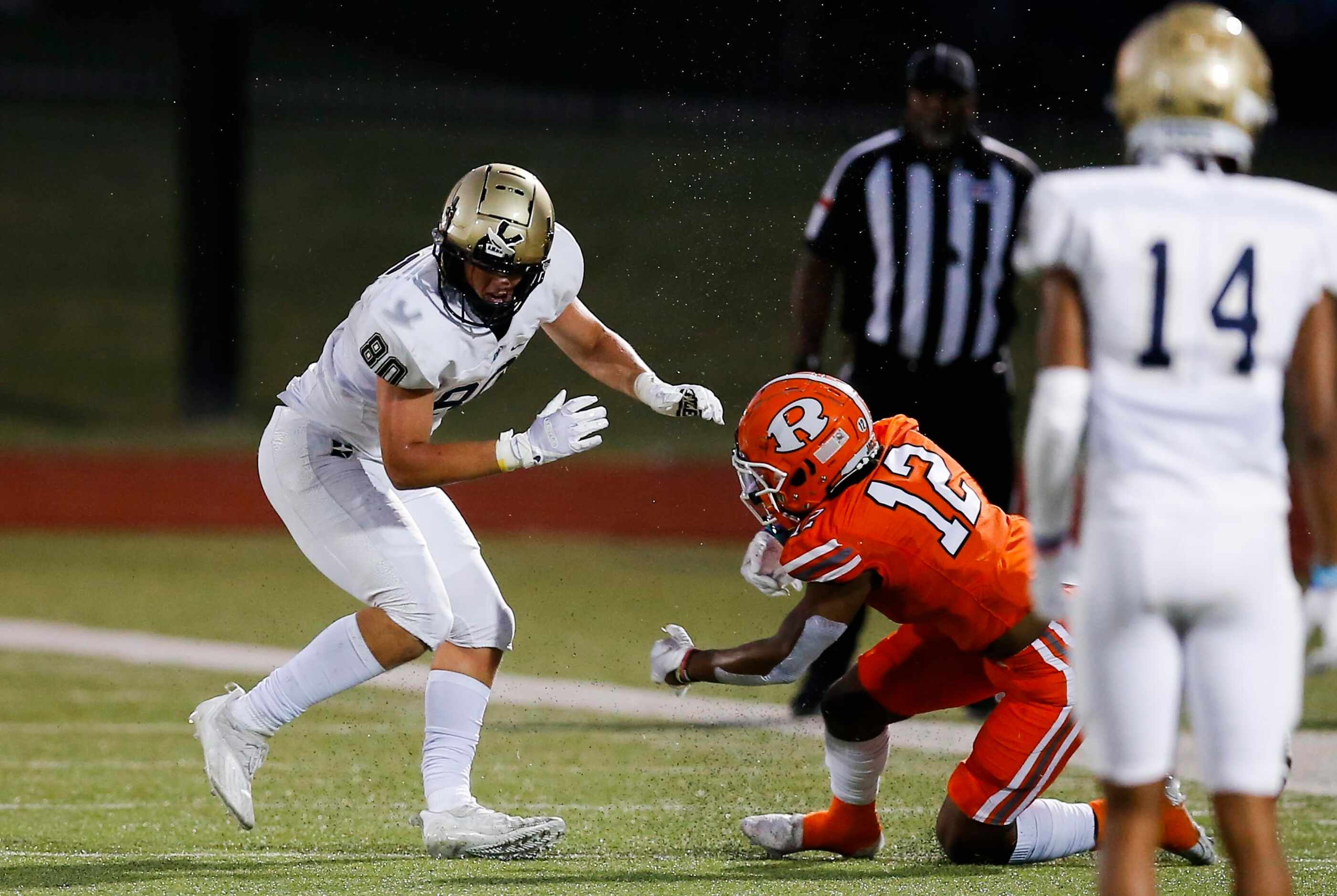 Rockwall junior safety Kevin Cunningham (12) hits Jesuit junior wide receiver Matty Wagner...