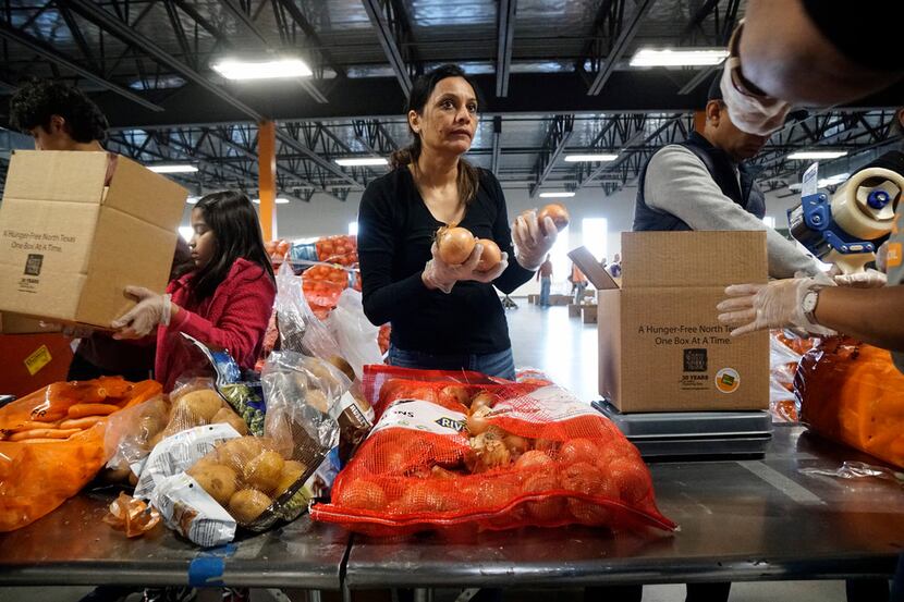 Smita Goyal boxes onions while volunteering with Hunger Mitao at North Texas Food Bank in...
