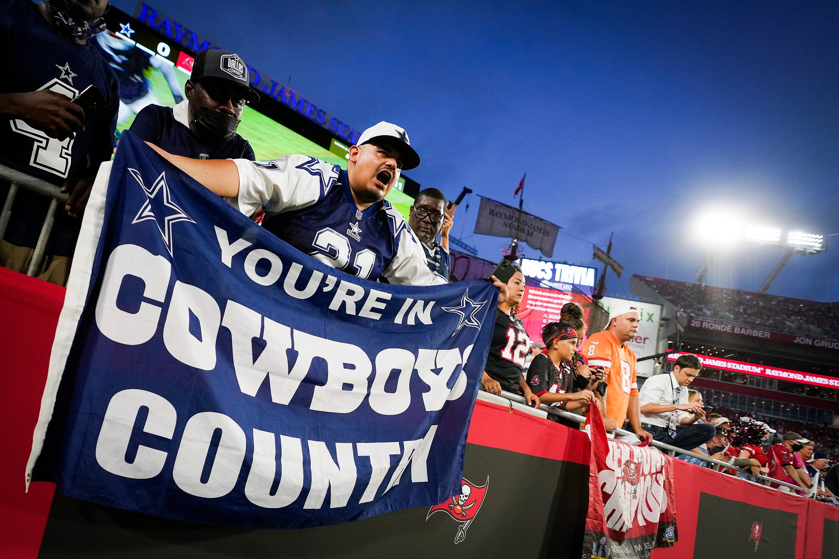 Dallas Cowboys fans cheer their team before an NFL football game against the Tampa Bay...