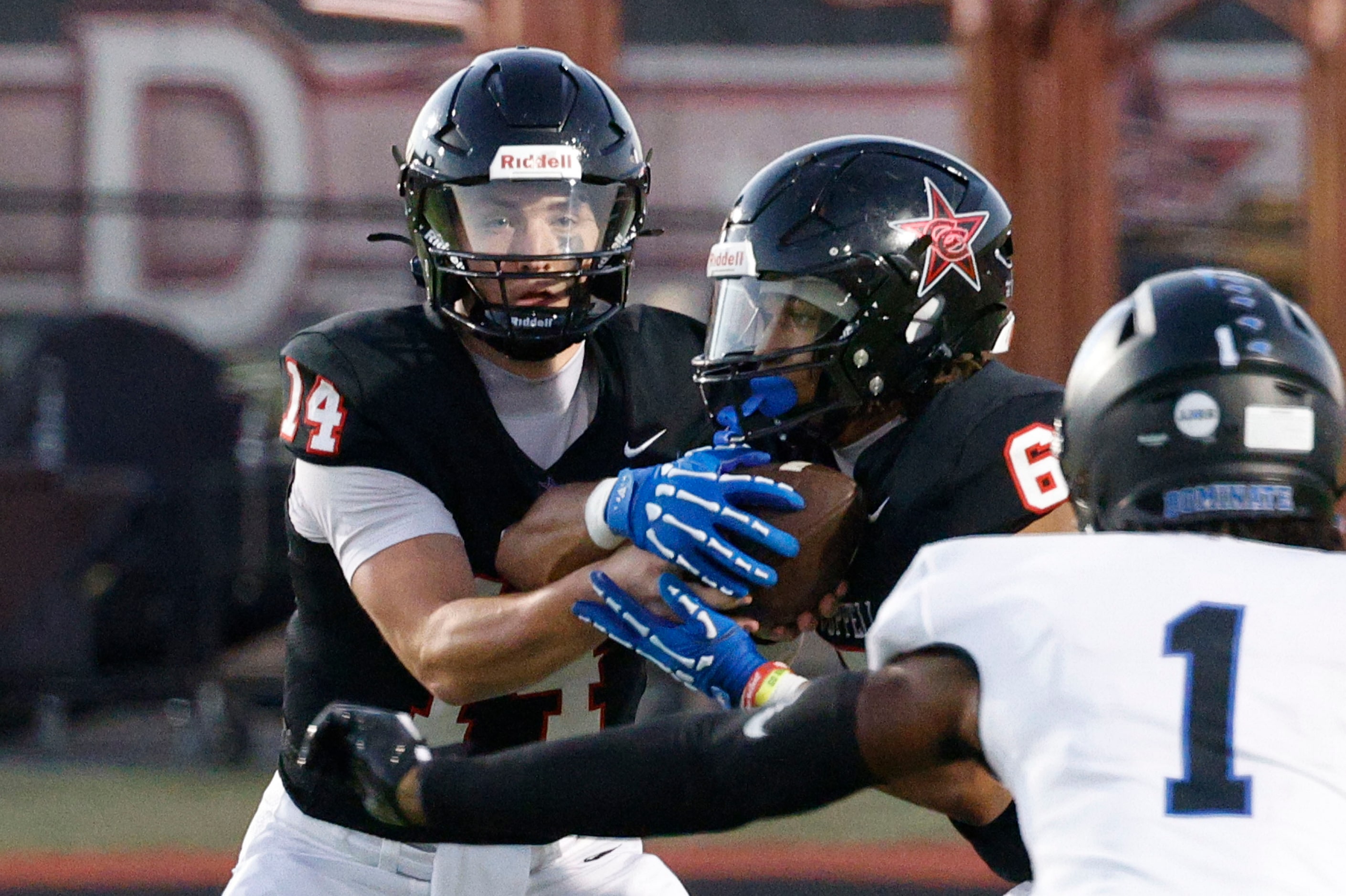 Coppell's quarterback Edward Griffin (14) hands off to Coppell's O'Marion Mbakwe (6) as...