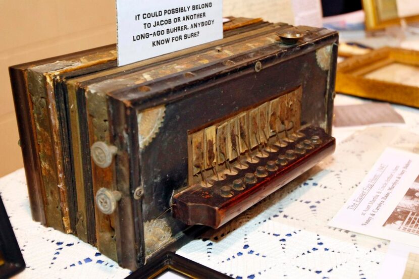 
A squeezebox accordion dating to the early 1900s was displayed among historic family photos...