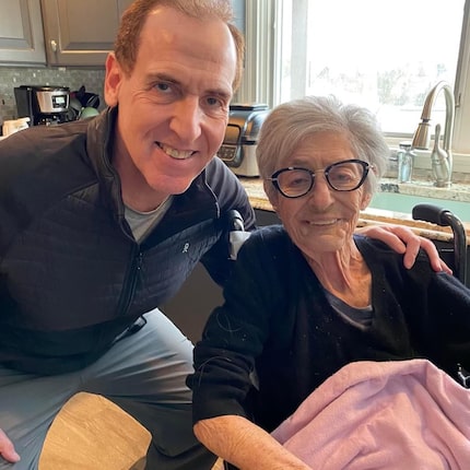 Brian Cuban crouches for a photo with his mother, Shirley.