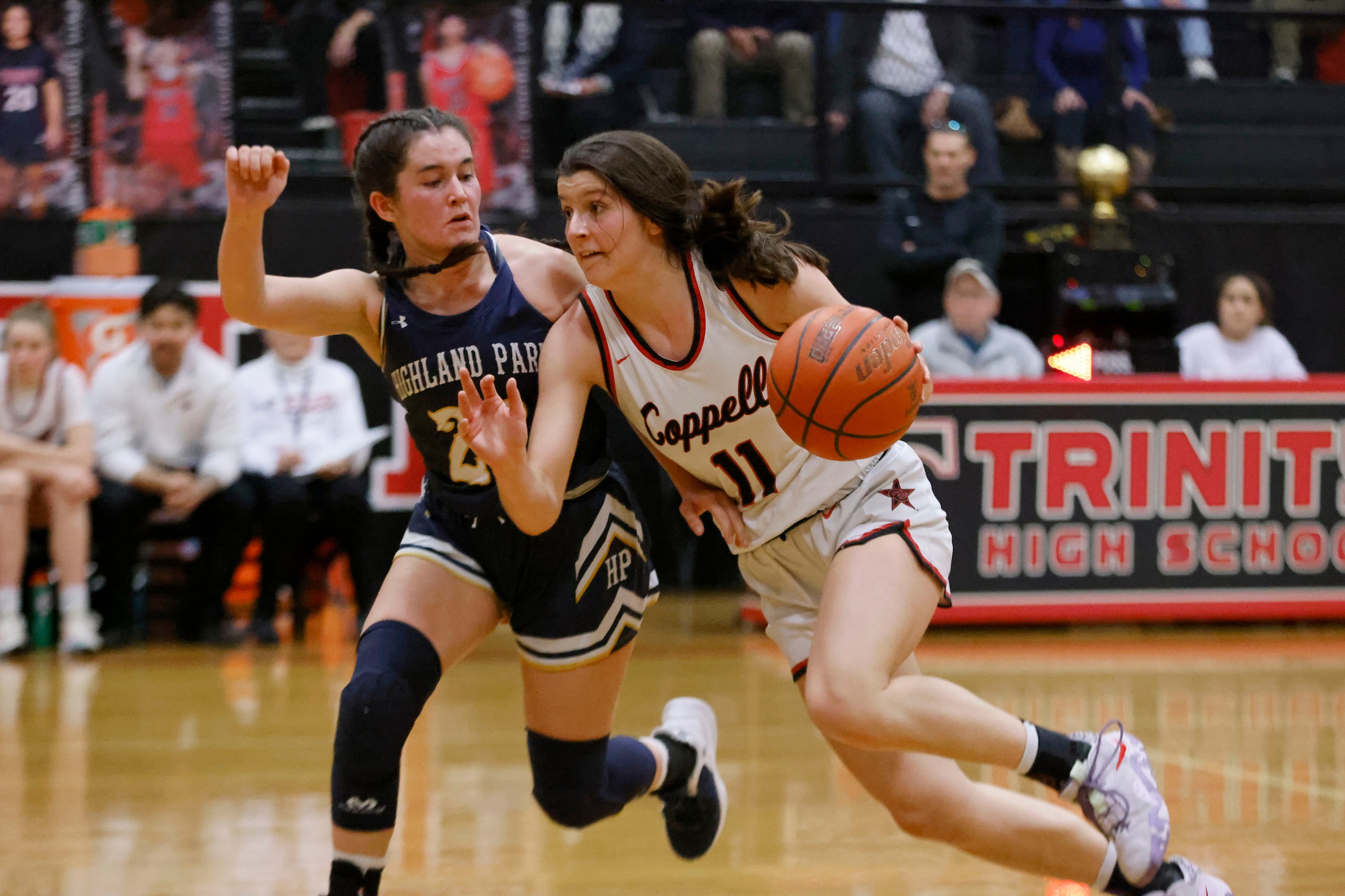 Coppell’s Waverly Hassman (11) drives past Highland Park’s Audrey Walker, left, during the...