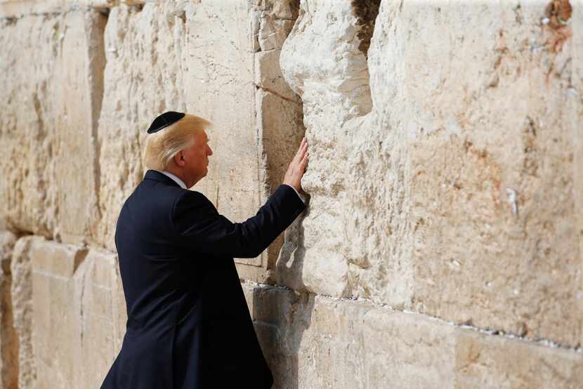 President Donald Trump touches the Western Wall, Judaism's holiest prayer site, in...